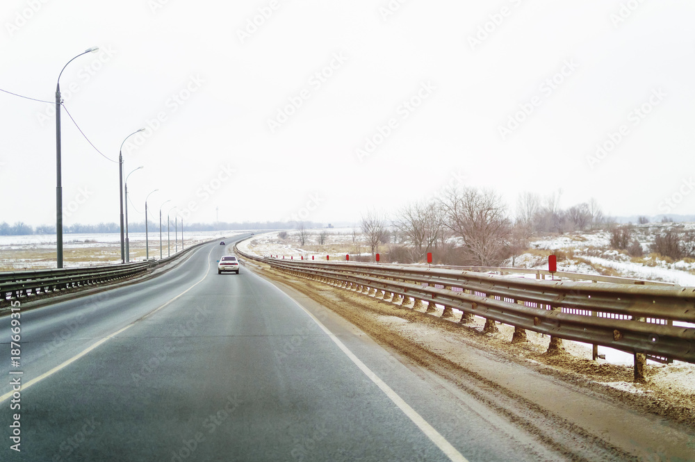 Winter track. The car is driving along the road. Winter track. The car is driving along the road.