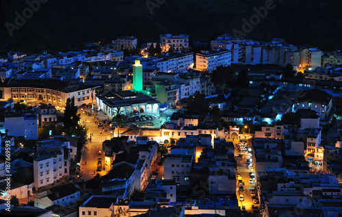 Chefchaouen at night with a green lighted mosque. © Karel