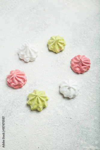 Sweet cakes "meringue" on a white vintage background, vertically.