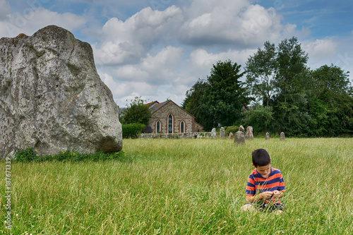 Child at stone circle site in England, Avebury.