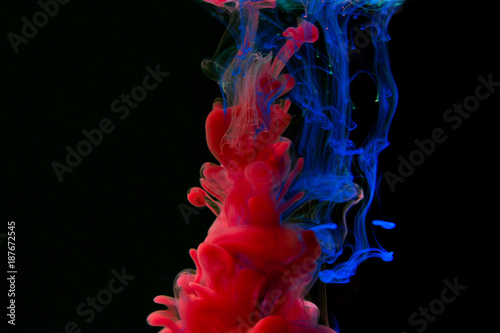 Color paint drops in water. Ink swirling underwater.