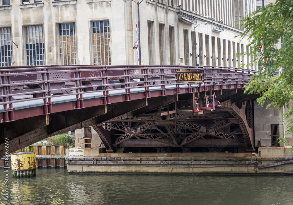 The Van Buren Street Bridge with traffic and Lake Michigan River surrounded by financial buildings, Chicago, IL, USA on the 5th of August, 2017