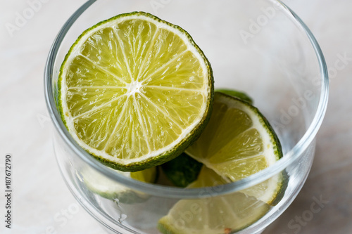 Fresh Lime Slices in Glass Cup.