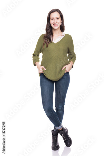 Beautiful young girl standing smiling on a white background photo