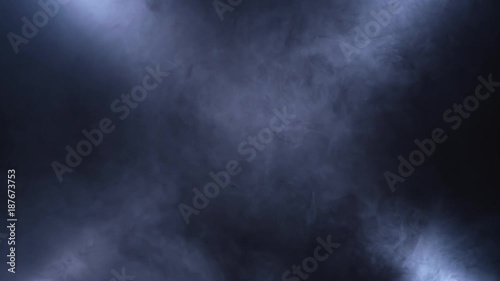 Rotation of the smoke veils under the lights on a black background photo