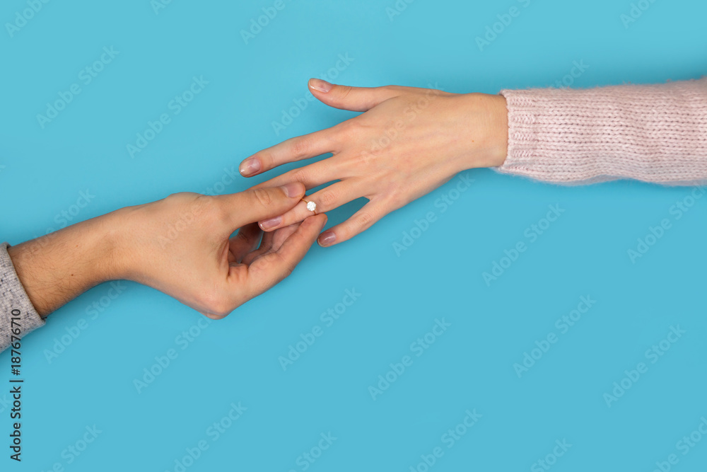 man holding wedding ring hands blue background girlfriend boyfriend proposal love story valentine man holding wedding ring hands blue background girlfriend boyfriend proposal love story valentine