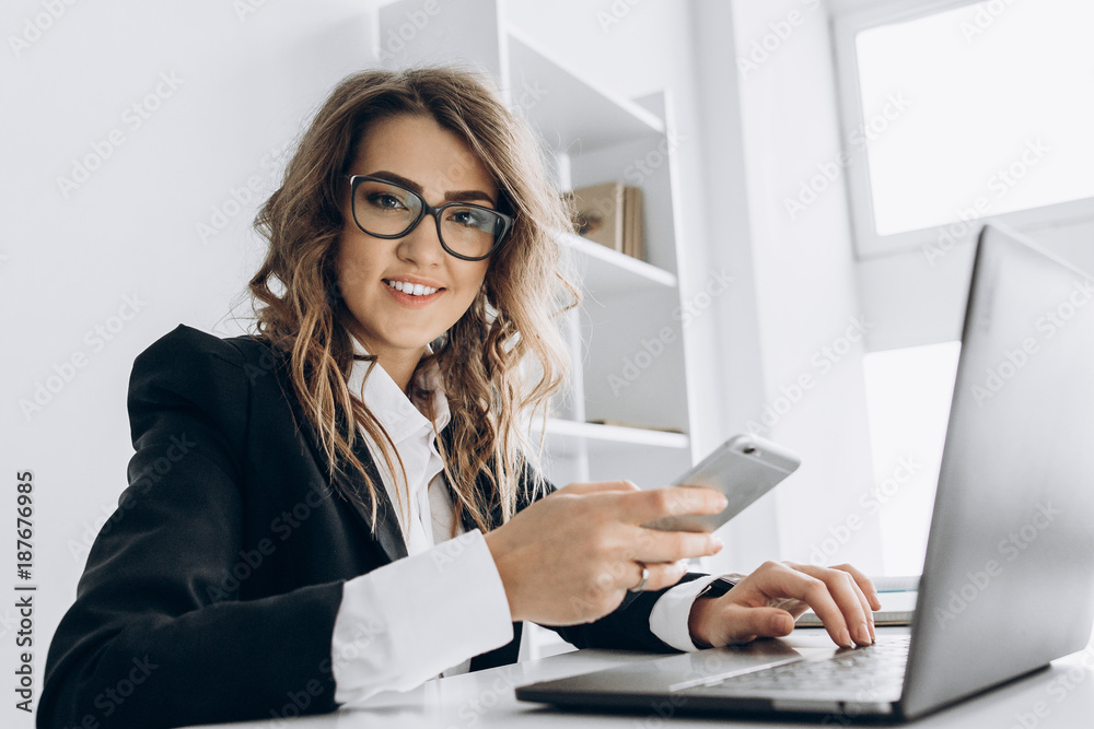 Modern beautiful business woman at her workplace in the office Modern beautiful business woman at her workplace in the office