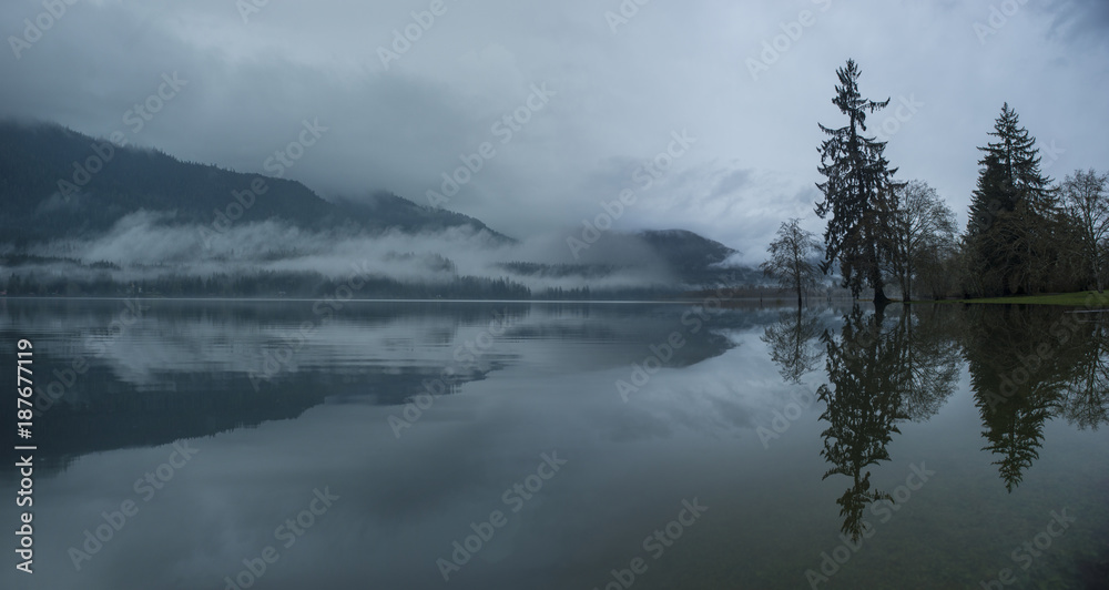 Scenic view of lake against mountains during foggy weather at Olympic National Park Scenic view of lake against mountains during foggy weather at Olympic National Park