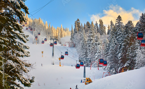 Poiana Brasov, Romania -12 January 2013 : Cable car in Poiana Brasov ski resort, Skiers and snowboarders enjoy the ski slopes in Poiana Brasov winter resort whit forests covered in snow photo