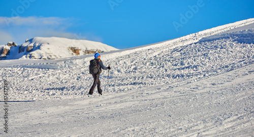 MADONNA DI CAMPIGLIO  ITALY-21 November 2014 Ski riders ride down a ski slope in Madonna di Campiglio mountain ski resort on snowy winter mountain scenic background