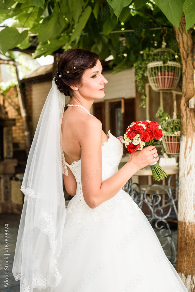 Beautiful Bride Portrait. Charming young bride with wedding bouquet