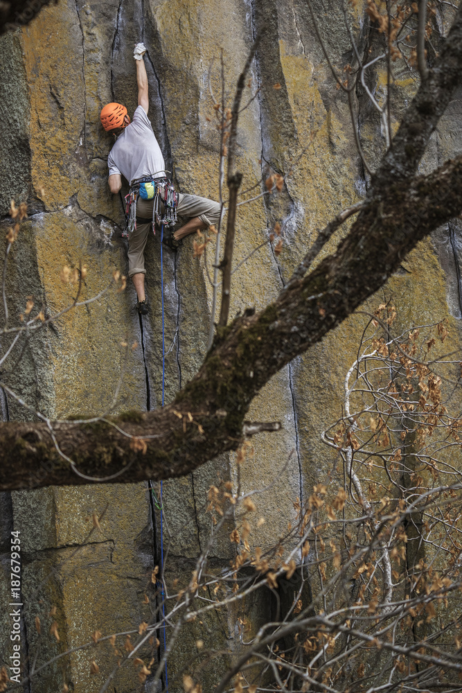 Low angle view of hiker rock climbing Low angle view of hiker rock climbing