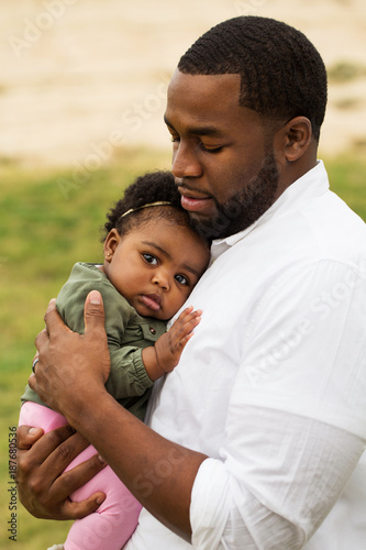 African American father holding his daughter. © digitalskillet1