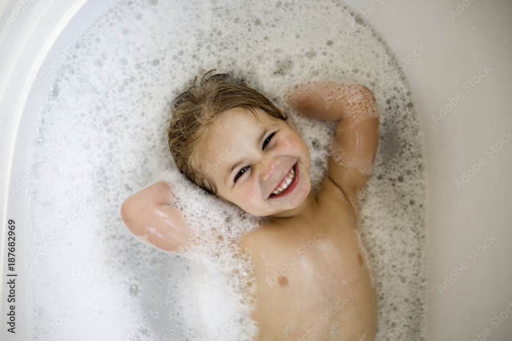 Portrait of smiling girl lying in bathtub Stock Photo Adobe Stock
