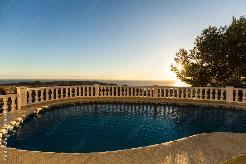 Swimming pool in the villa at sunrise.