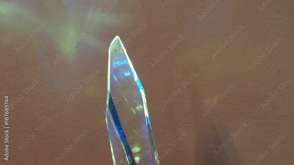 Crystal turning clockwise showing bule & yellow reflections