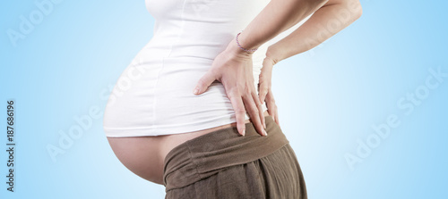 Pregnant woman with back pain photo