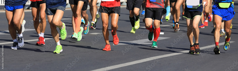 marathon runners legs running on city road