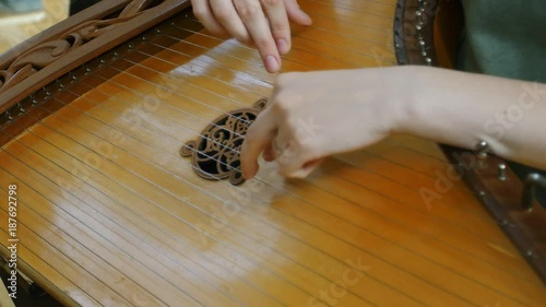 Folk musician playing gusli photo