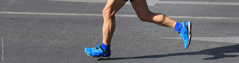 marathon runner legs running on city road