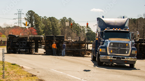 Logging truck turned over on highway