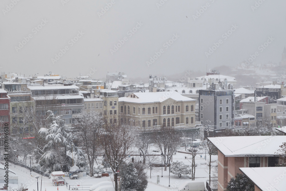 Obraz premium A winter view from the city of Istanbul with houses covered with white snow