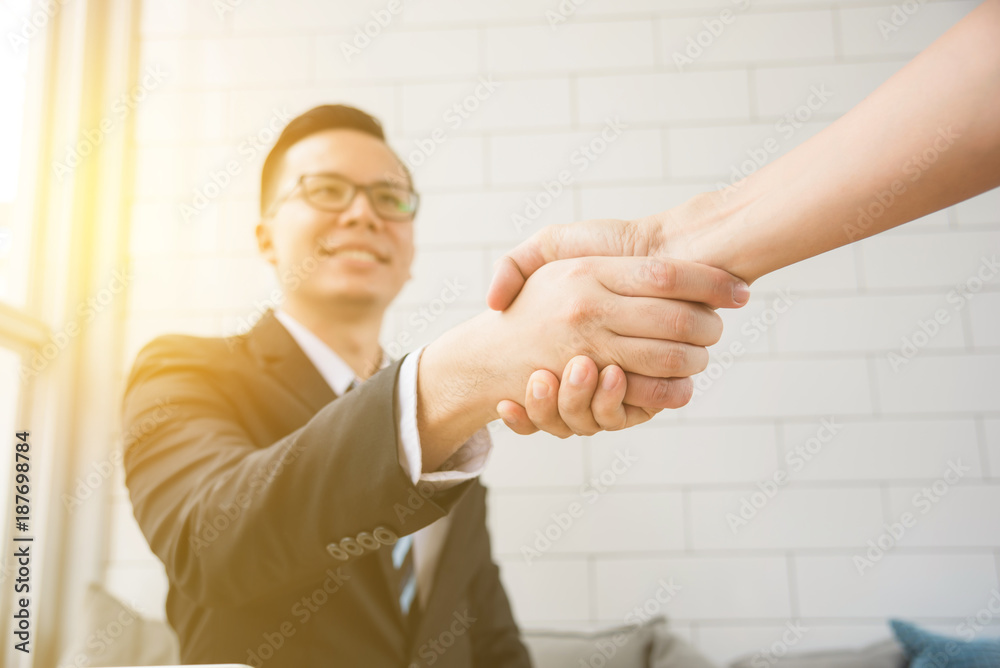 Φωτογραφία Asian businessman shaking hand with partnership and smile