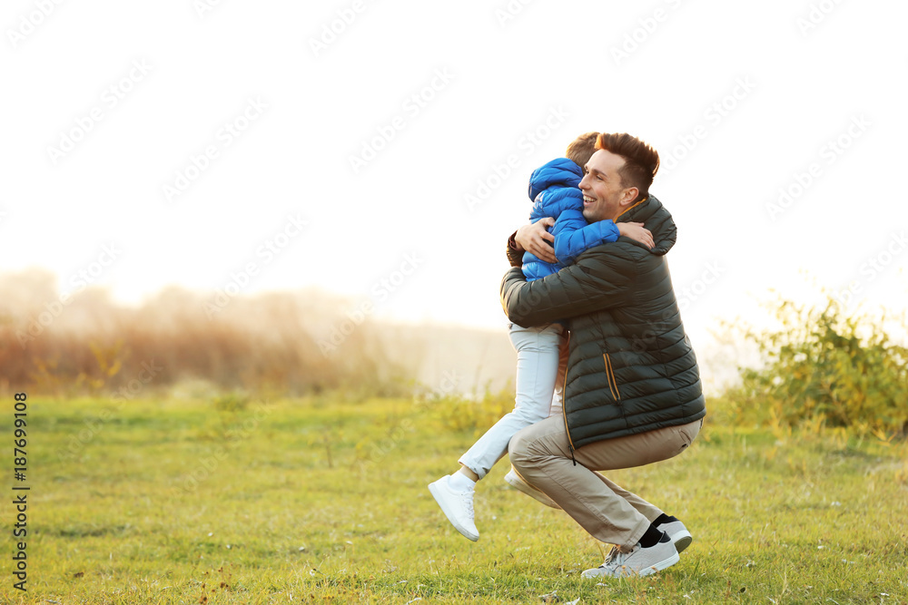 Little boy hugging his father outdoors Little boy hugging his father outdoors