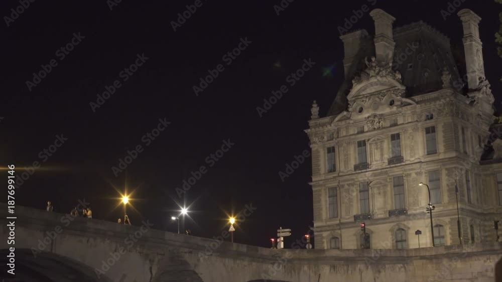 PARIS, FRANCE – SEPTEMBER 2016 : Video shot of of bridge and riverside from seine River at night PARIS, FRANCE – SEPTEMBER 2016 : Video shot of of bridge and riverside from seine River at night