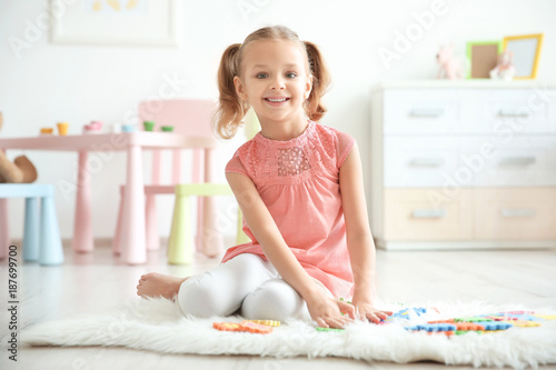 Cute little girl playing wi...