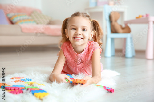 Cute little girl playing wi...