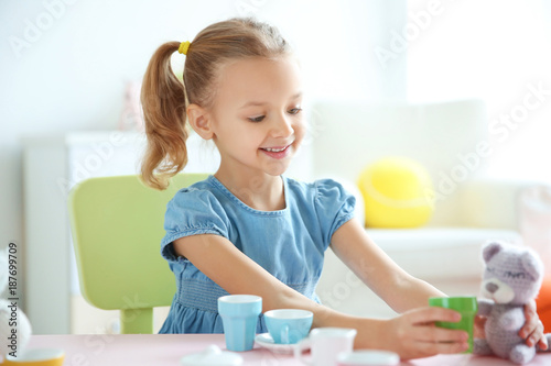 Cute little girl playing at...