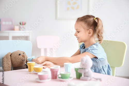 Cute little girl playing at...