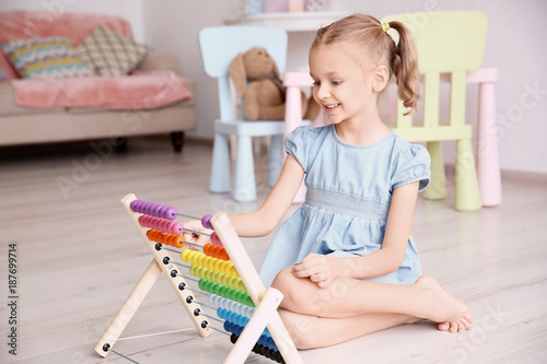 Cute little girl playing wi...