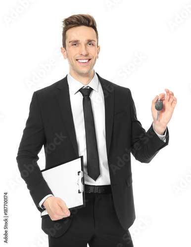 Young salesman holding car ...
