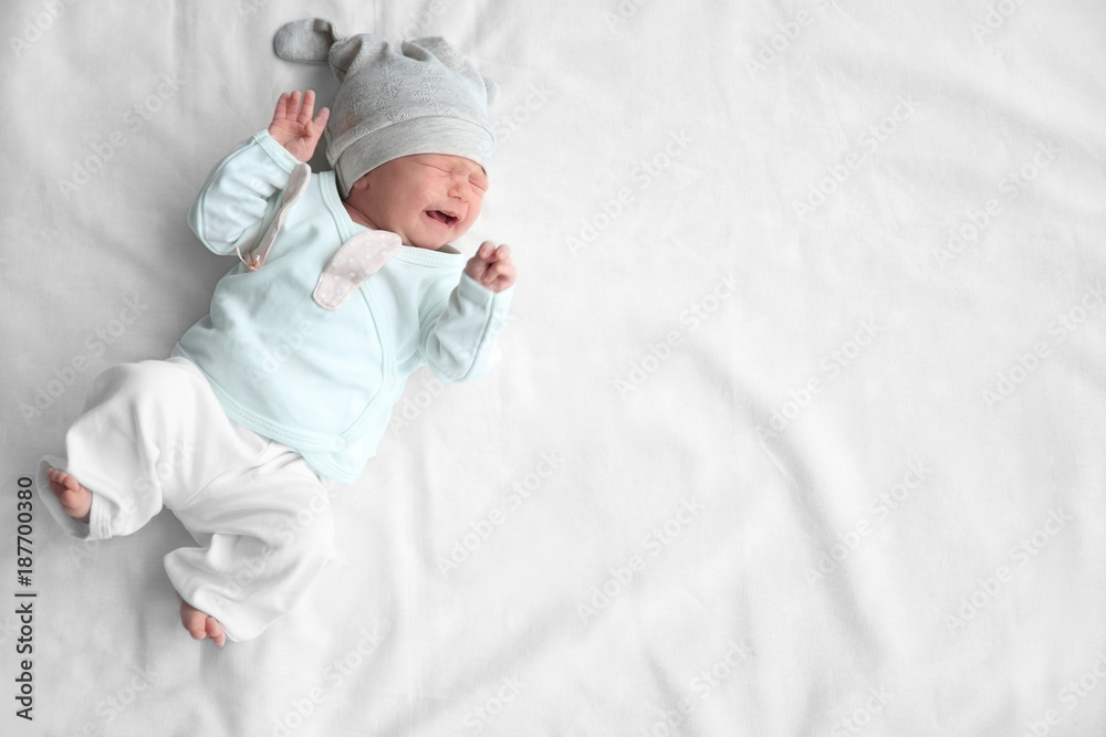 Cute newborn baby girl lying on bed Cute newborn baby girl lying on bed