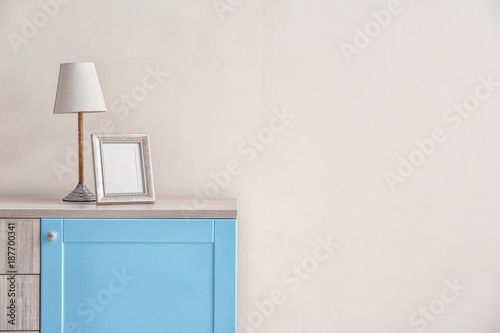 Lamp and empty frame on woo...