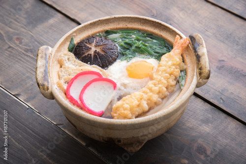 nabeyaki style udon with shrimp tempura photo