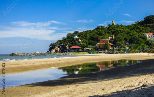 A view from the beach and Turtle Mountain (Khao Tao) with golden Buddha statues in Hua Hin, Thailand