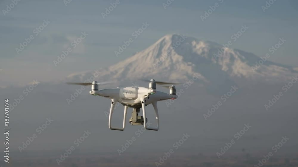 Aircraft copter pilot flight over natural winter scenic place isolated closeup, at background white big cliff ridge. Radio-controlled multirotor helicopter, working by wireless, no people around