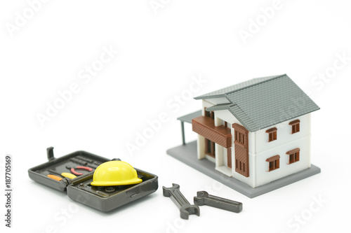 House Models and Equipment Models There are yellow construction helmet models. Home Repair and Construction . as background property real estate concept with copy space for your text or design.