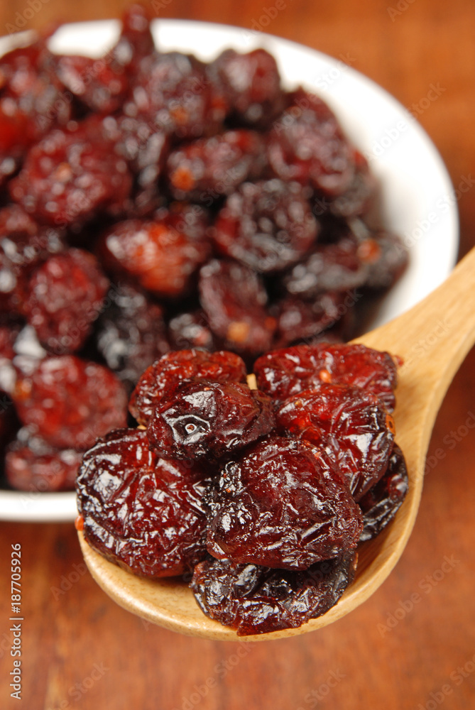 Red berries on a wood spoon Red berries on a wood spoon