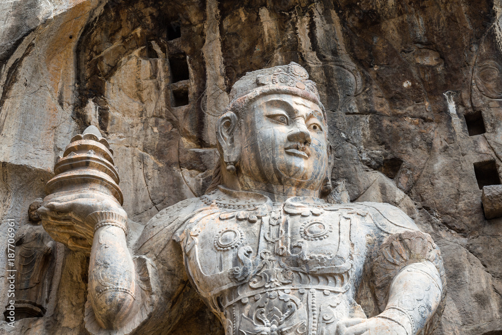 Buddhist sculptures in Fengxiangsi Cave, the main one in the Longmen Grottoes in Luoyang, Henan, China. Longmen is one of the 3 major Buddhist caves of China, and a World heritage Site.