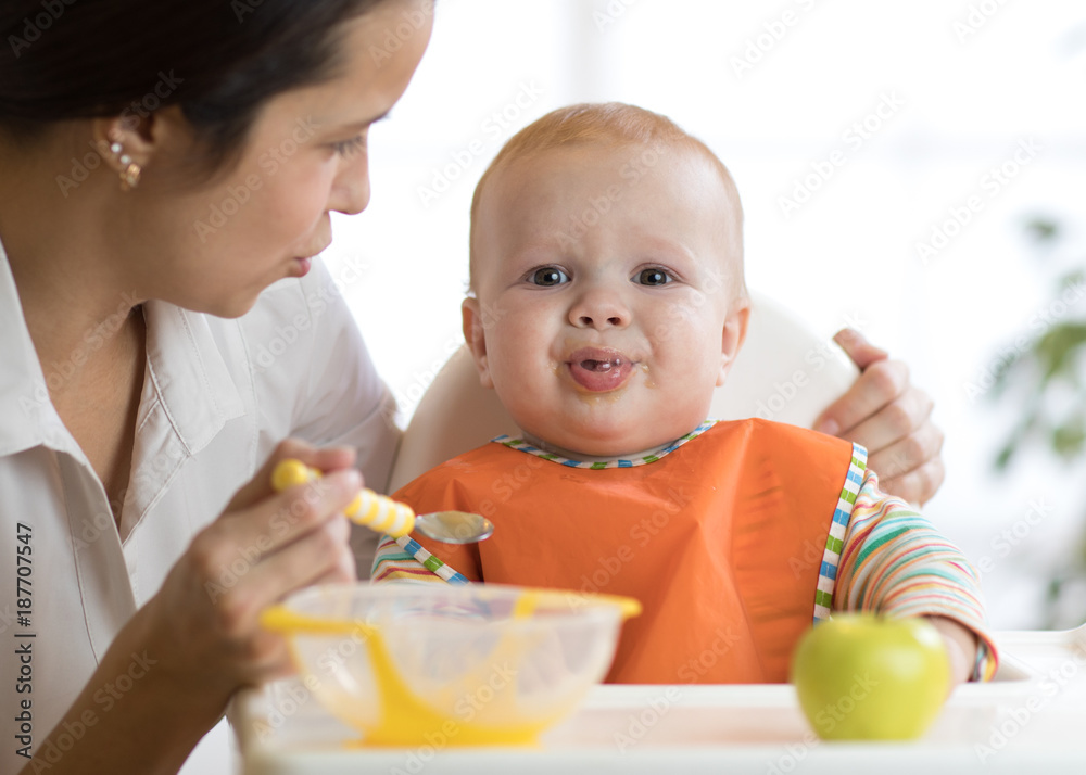 Mom feeds her kid. Baby is crying, capricious and refusing to eat Mom feeds her kid. Baby is crying, capricious and refusing to eat
