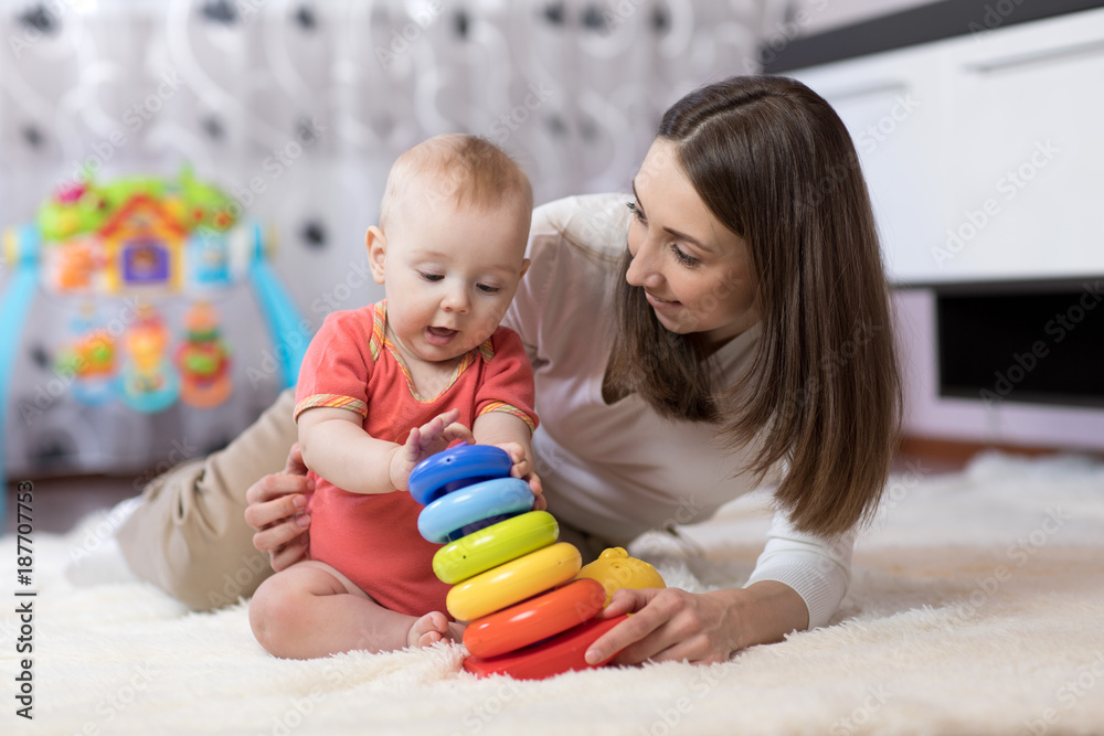 © Oksana Kuzmina - little child boy and his mommy play with toys at home
