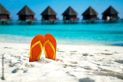 Sandals on the beautiful beach - summer vacation