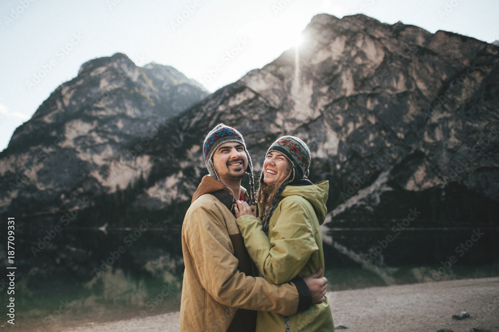 happy retired couple on vacation hugging in a valley in the Dolomites mountains happy retired couple on vacation hugging in a valley in the Dolomites mountains