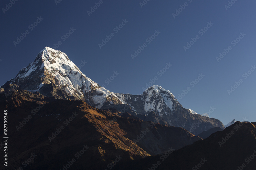 Fototapeta premium View of Annapurna South at sunset from Poon Hill with buddhist flags. Himalaya Mountains, Nepal
