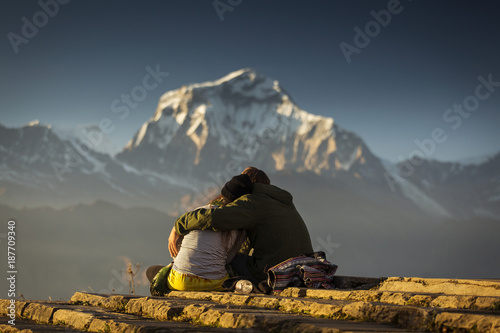 Couple in love enjoying view of Dhaulagiri from Poon Hill. Himalaya Mountains, Nepal.