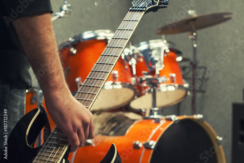 Solo guitarist who came to the presentation, hands and neck of a guitar close-up. Selective focus.